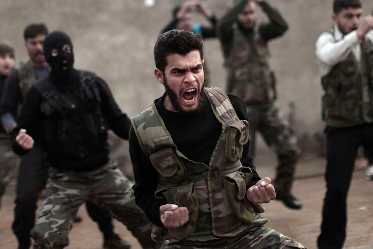 Rebels train in Maaret Ikhwan, Syria. Their instructoris an army defector.