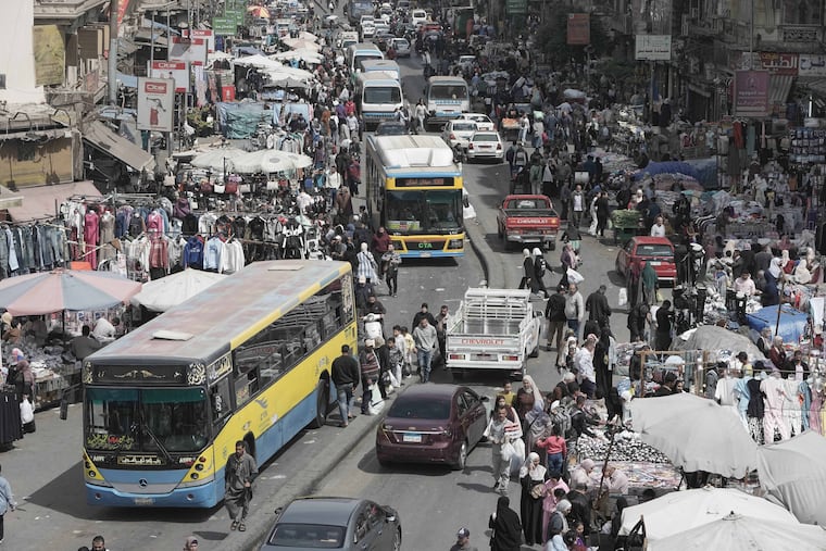 People and vehicles crowd at a popular market in Cairo, Egypt, Tuesday, March 12, 2026. (AP Photo/Amr Nabil)