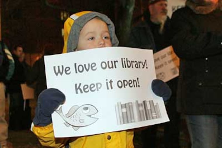 Ryan Ganzel, 4, holds a sign during a rally to save the Fishtown library branch on Monday. (Yong Kim / Staff Photographer)