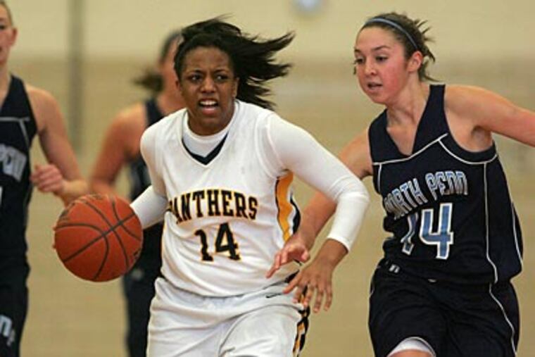 Cheltenham's Tiffany Johnson dribbles down the court covered by North Penn's Brenda McDermott. (David Swanson/Staff Photographer)