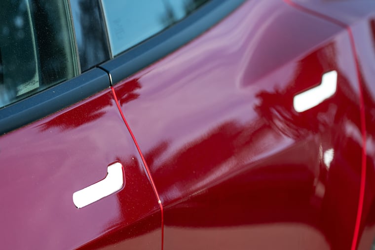 Door handles on a Tesla vehicle at a dealership in Colma, Calif. Teslas have flush, electronic handles that can stop working in some crashes.