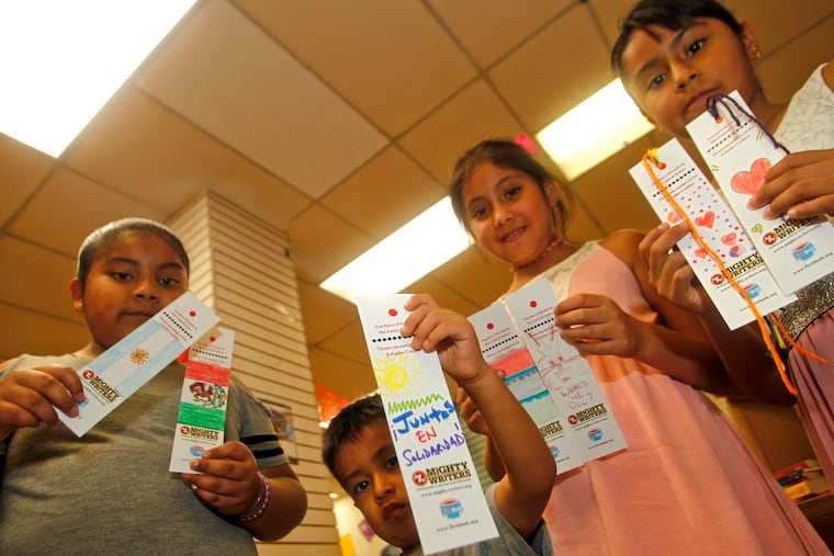 Left to right: Jocylyn, 10, Isaac, 4, Amy, 8, and Dana, 10, help display some of the book marks that were supposed to be sent to the Berks County Residential Center.