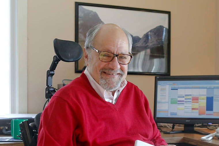 Psychologist Dan Gottlieb at his Cherry Hill home holding his newest book "The Wisdom We're Born With." It is not of the how-to genre.