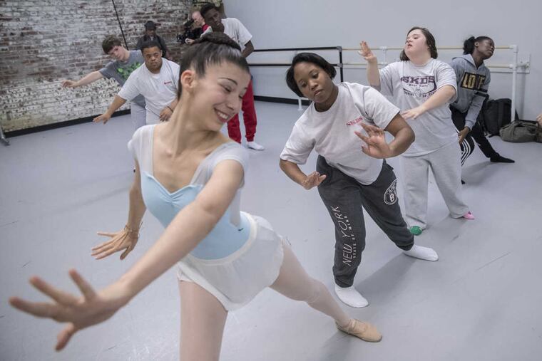 Pennsylvania Ballet II dancer Halle Sherman, left, helps Tamika Lincoln, a student at St. Katherine Day School, during rehearsals for a joint performance by young professional dancers and students with disabilities. Sherman said: 'We are friends forever!'