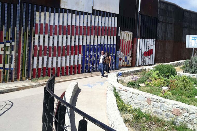 An American flag mural, upside down and with crosses instead of stars, was painted by Mexican citizens who served in the U.S. military, but were deported.