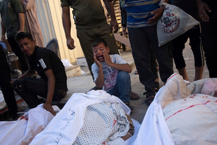 Palestinians mourn relatives killed in the Israeli bombardment of the Gaza Strip, in front of the morgue in Deir al Balah, on Tuesday, Oct. 31, 2023.