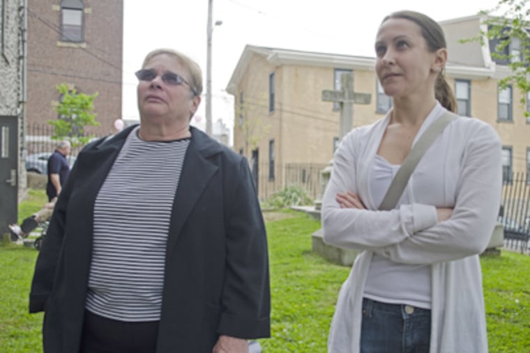 Megan Clayton (right) was married at St. Mary of the Assumption Church in Manayunk on New Years Eve, her mother, Mary Beth Syrnick (left) baptized and wed all three of her children at the church. ( Richard Kauffman / Staff Photographer )