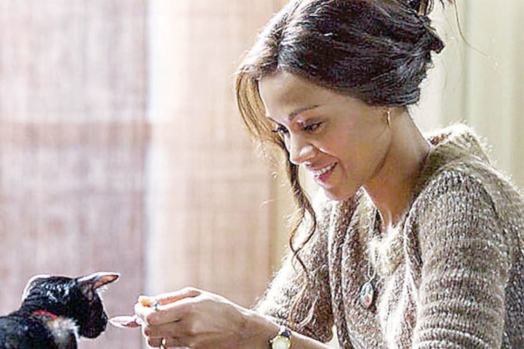 ROSEMARY'S BABY -- Pictured: Zoe Saldana as Rosemary -- Zoe Saldana (with cat) stars in the NBC miniseries “Rosemary’s Baby” (Roger Do Minh/NBC)