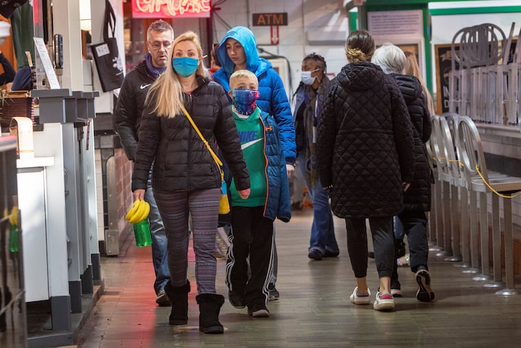 Patrons of Reading Terminal Market wearing and not wearing masks on Monday morning, April 11, 2022. The Philadelphia health department reinstated its indoor mask mandate due to COVID-19.