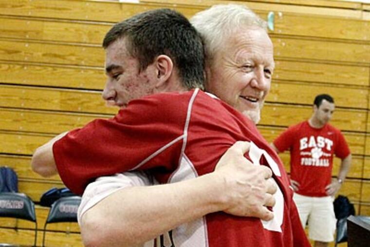 Christian Strauss hugs coach Karl Moehlmann after Cherry Hill East won its 300th match. (Elizabeth Robertson/Staff Photographer)