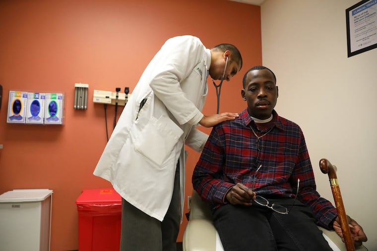 Terrance Hill, 40, is examined by Santosh Saraf, a hematologist-oncologist, during a checkup to manage his sickle cell disease at University of Illinois Hospital.