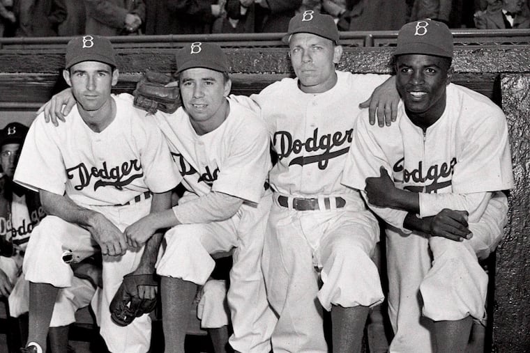 Jackie Robinson poses with his Brooklyn Dodgers teammates at Ebbets Field on April 15, 1947 — the day he broke the color barrier in baseball.