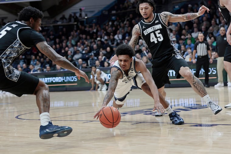 Villanova’s Acaden Lewis (middle) tries to grab the ball from Georgetown on Wednesday.