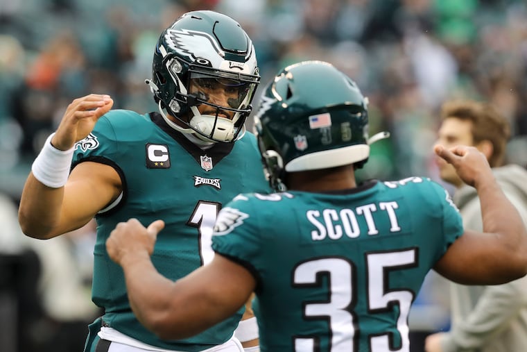 Eagles quarterback Jalen Hurts with running back Boston Scott before the NFC championship game.