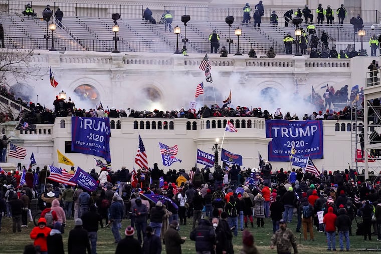 In this Jan. 6, 2021, file photo violent rioters, loyal to President Donald Trump, storm the Capitol in Washington. Following the riot, large corporate PAC donors decided to slash their political donations.
