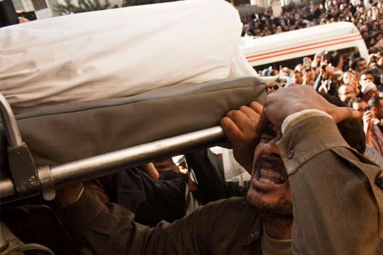 Mourning at a funeral for victims of the Mansoura attack claimed by an al-Qaeda-inspired group. (AP Photo)