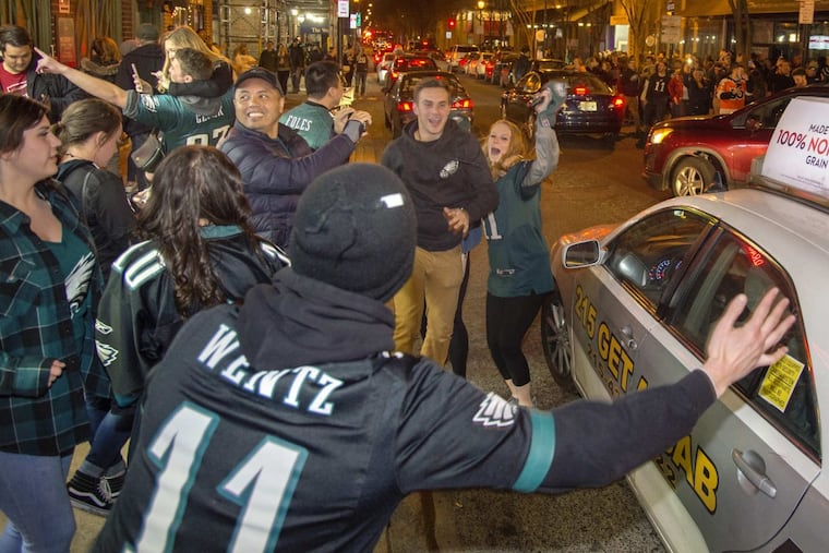Eagles fans celebrate as they leave the bars along 15th & Locust Streets after the Eagles beat the Vikings for the NFC championship.