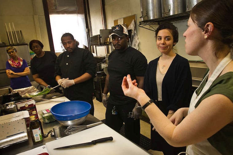 At Jane Addams Place in West Philadelphia, Deb Bentzel of the nonprofit Food Trust leads a nutrition and preparation training session for the shelter's kitchen staff. ( ALEJANDRO A. ALVAREZ / Staff Photographer )