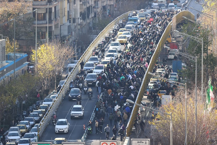 Protesters march in downtown Tehran, Iran, on Monday.