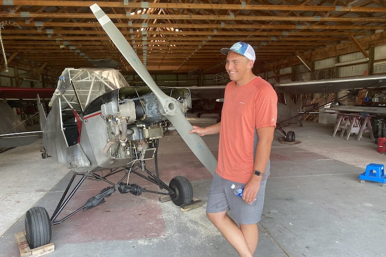 Pilot Landon Lucas, 18, next to the 1946 J-3 aircraft he successfully landed on the Ocean City- Somers Point bridge on Monday. The plane suffered "not even a scratch," he said.