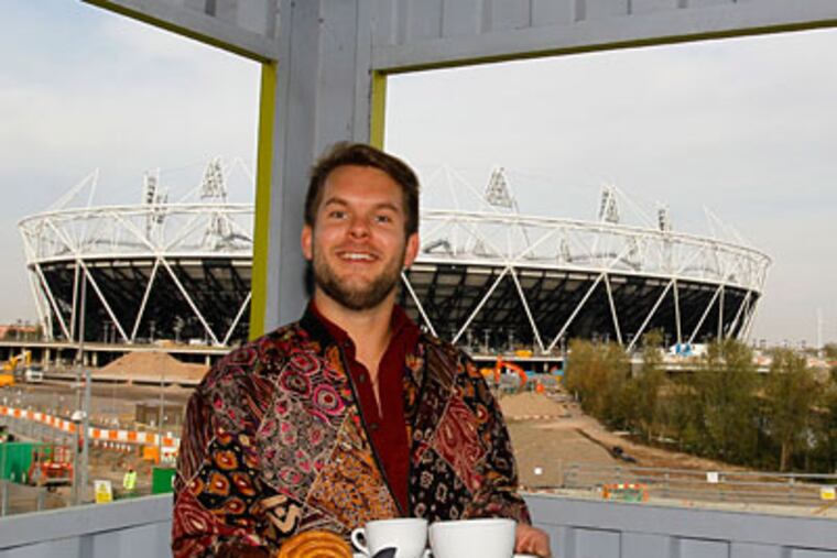 Tom Seaton, owner of the Container Cafe right near the Olympic Park in London, is one of many merchants worried about the effect the games will have on small, nearby businesses this summer. (KIRSTY WIGGLESWORTH / Associated Press)