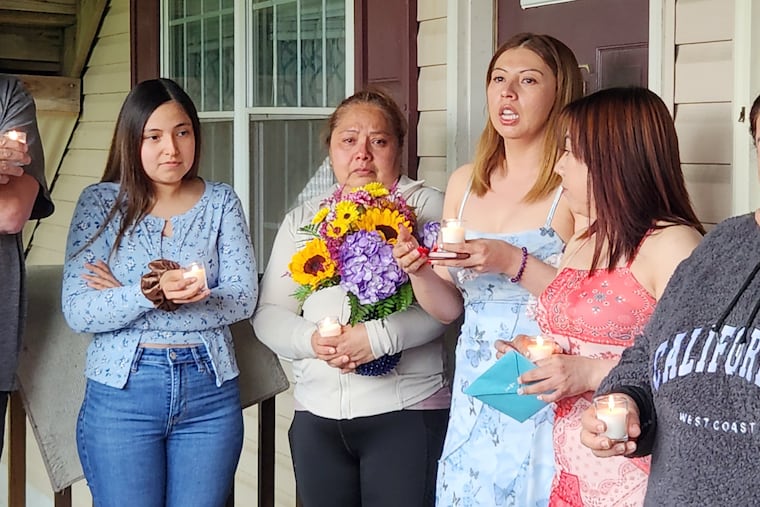 Family members, including Maria Hernandez, the wife of Erasmo Zavala Almanza, holds flowers during a vigil for for her husband at their home in Temple, Berks County on May 10.