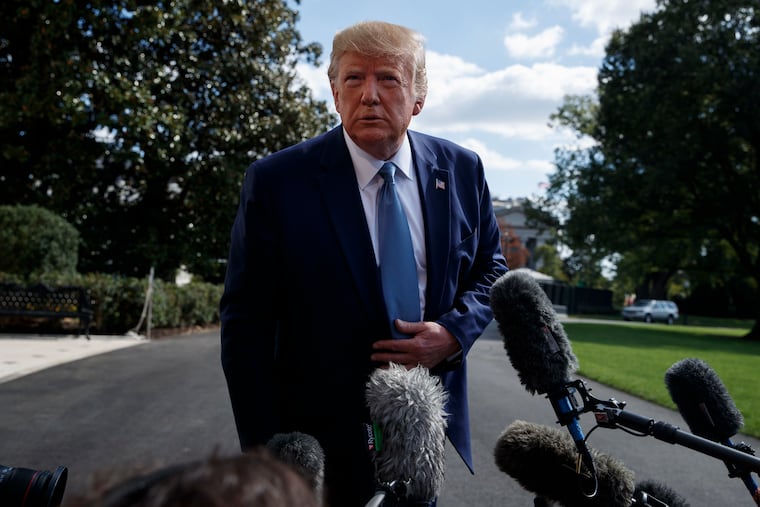 President Donald Trump talks to reporters on the South Lawn of the White House on Friday.