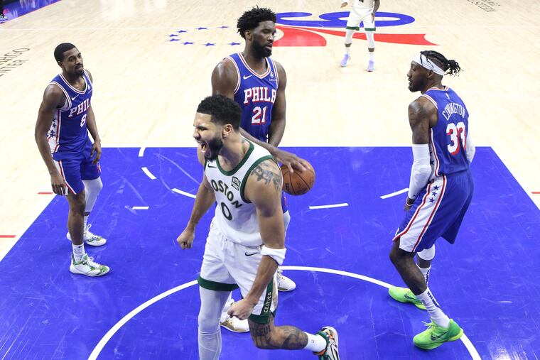 Celtics' Jayson Tatum (bottom) celebrates after tipping in a basket late in the fourth quarter at the Wells Fargo Center on Nov. 15.