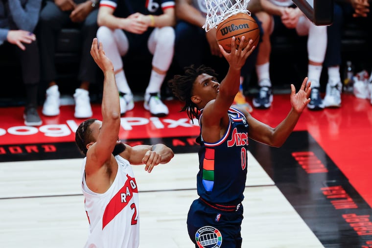 Sixers guard Tyrese Maxey lays-up the basketball past Toronto Raptors center Khem Birch in the second quarter during game three of the first-round Eastern Conference playoffs on Wednesday, April 20, 2022 in Toronto.