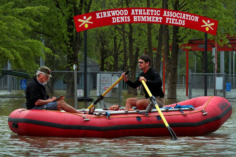 Dan Macheca (right) and Mitch Wieldt get their paddling in as they row along Marshall Road in Meramec River flood water, passing the Kirkwood Athletic Association baseball and softball fields near Greentree Park on Friday, May 3, 2019. The river sits at moderate flood stage but will rise more than four more feet before cresting right at major flood stage early Sunday, an estimated 25.1 feet. The men are training for a 280-mile rafting trip through the Grand Canyon on the Colorado River.