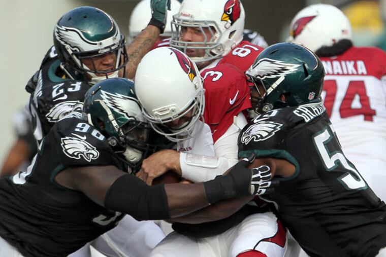 Bennie Logan and Brandon Graham sack the Cardinals' Carson Palmer during the second quarter. (Yong Kim/Staff Photographer)