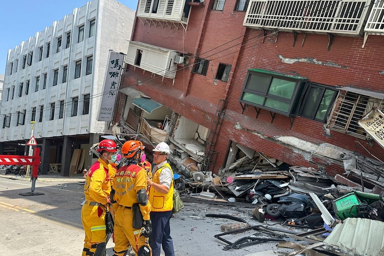 Members of a search and rescue team prepare outside a leaning building in the aftermath of an earthquake in Hualien, eastern Taiwan, on Wednesday, April 3, 2024.