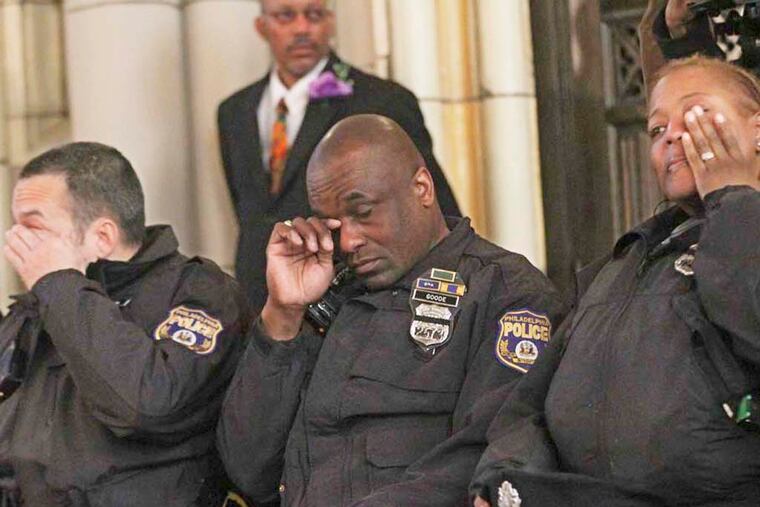 22d District police officers (from left) Brian Saba, Michael Goode, and Tanya Averette wipe away tears during the memorial Mass. 'I thought this service . . . shows there's great support for us out there,' Saba said.
Michael Bryant / Staff Photographer
