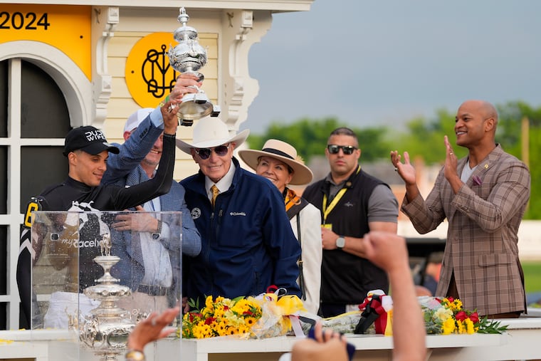 Seize the Grey jockey Jaime Torres (left) and trainer D. Wayne Lukas (in cowboy hat) celebrate their Preakness Stakes victory on May 18, 2024.