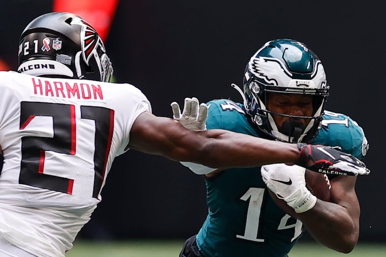 Eagles running back Kenneth Gainwell runs with the football against Atlanta Falcons strong safety Duron Harmon on Sunday, September 12, 2021 in Atlanta.