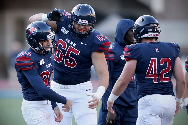 Penn kicker Daniel Karrash (left) celebrates with offensive lineman Ben Hoitink (65) after kicking the game-winning field goal in the final seconds.