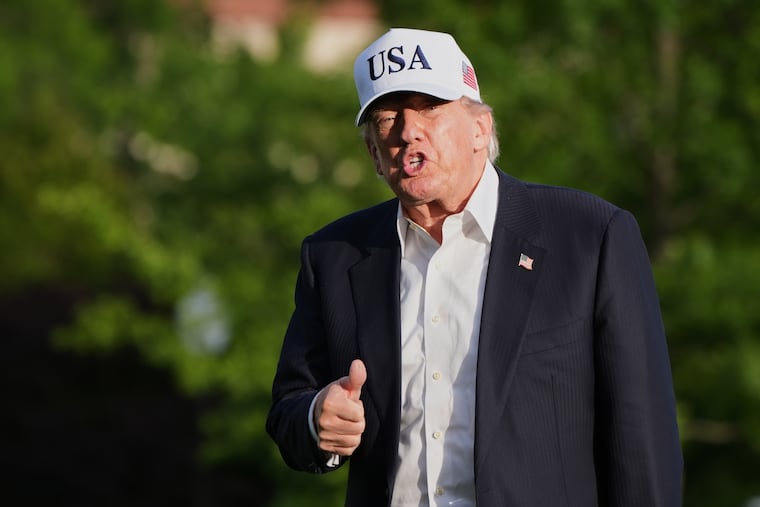 President Donald Trump gestures to reporters as he walks across the South Lawn of the White House, Friday, May 15, 2026, in Washington.