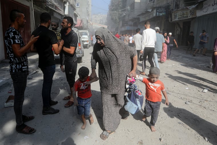 Palestinians evacuate wounded people following an Israeli airstrike in Bureij refugee camp, Gaza Strip, on Thursday.