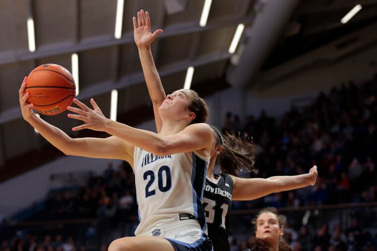 Villanova's Maddy Siegrist (left) goes up for a reverse layup as Providence's Olivia Olsen defends in the first half Friday at Finneran Pavilion. Siegrist led the Wildcats with 23 points.