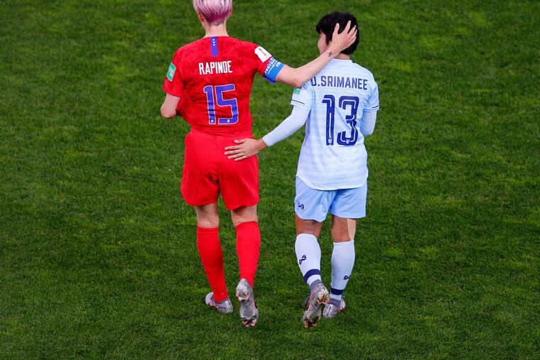 Thailand's Orathai Srimanee and the United States' Megan Rapinoe walked together on the field after the Americans' historic 13-0 rout in the Women's World Cup.
