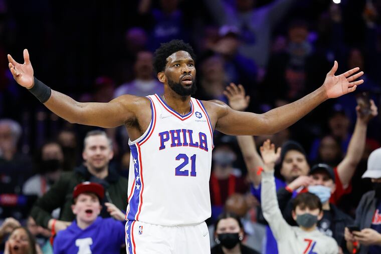 Sixers center Joel Embiid raises his arms after making a lay-up and getting fouled in the fourth quarter against the Cleveland Cavaliers on Saturday, February 12, 2022 in Philadelphia.