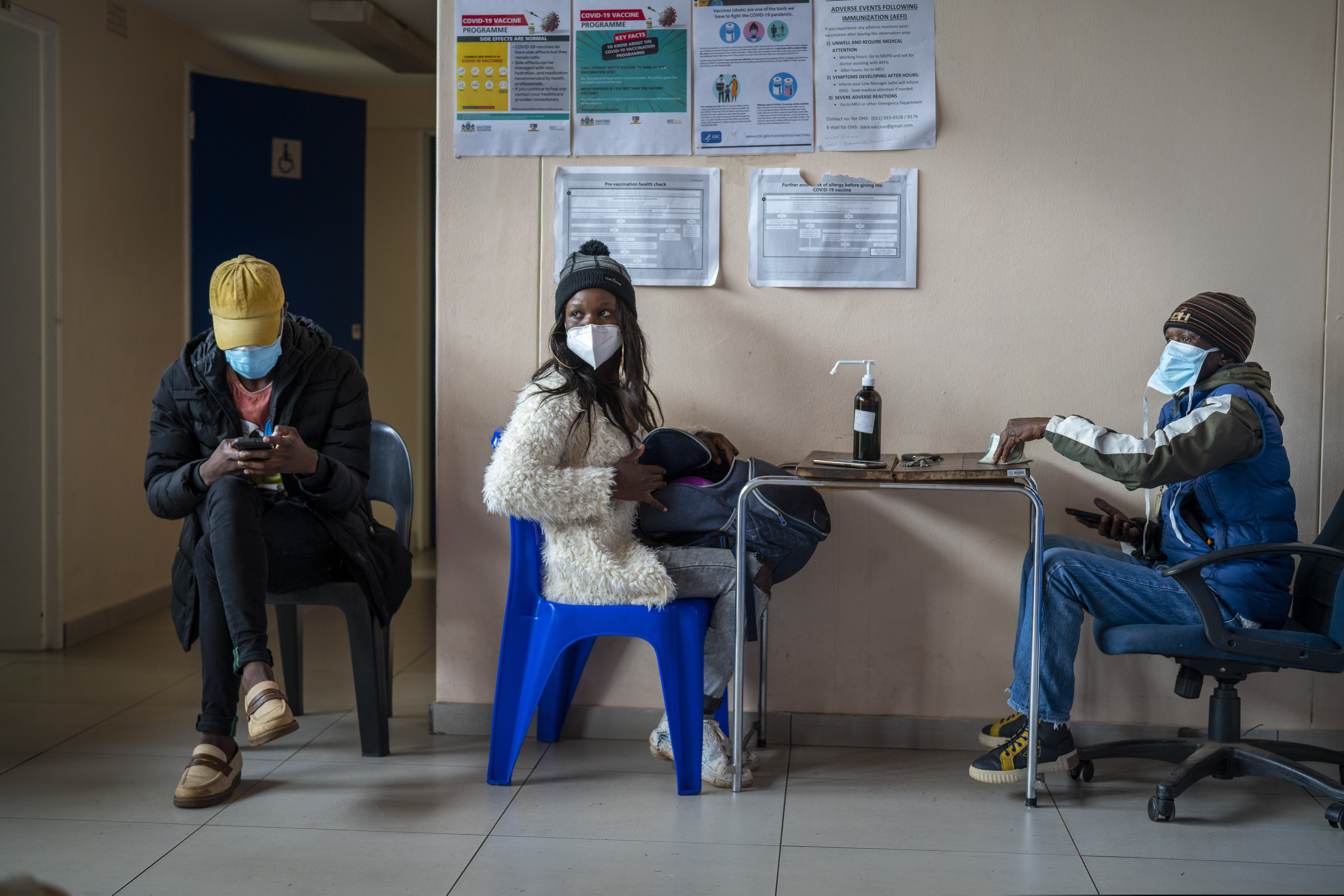 Takalane Mulaudzi, 29, is processed before getting her COVID-19 vaccination at Soweto's Baragwanath hospital Monday Dec.13, 2021. Despite having adequate supplies of more than 19 million vaccine doses, South Africa's vaccination campaign has lagged. Around 38 percent of the adult population in South Africa has been vaccinated.