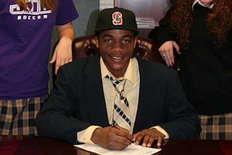 Cleo Robinson of Paul VI H.S., headed to Stanford in the fall to play football, signs his letter of intent. (Credit: Paul VI H.S.)