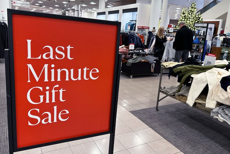A sign aimed at last-minute holiday shoppers is displayed at a retail store in Schaumburg, Ill., Monday, Dec. 18, 2023.