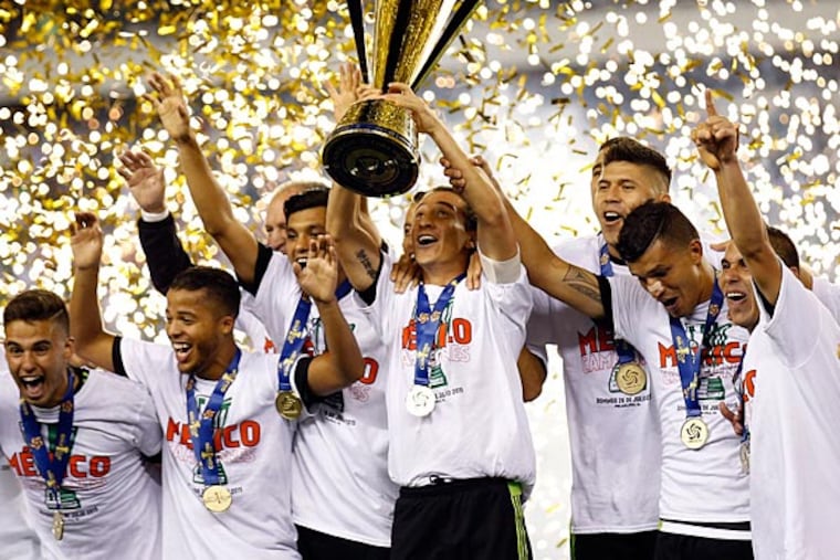 The Mexican men's soccer team celebrates their CONCACAF 2015 Gold Cup win. (Yong Kim/Staff Photographer)