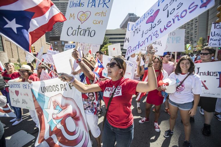 Asdrey Irizarry, center, representing Unidos PA’PR helps lead the Puerto Rican Day Parade as members of the organization were asking for donations for the island of Puerto Rico following the devastation of Hurricane Maria on Sunday September 24, 2017.