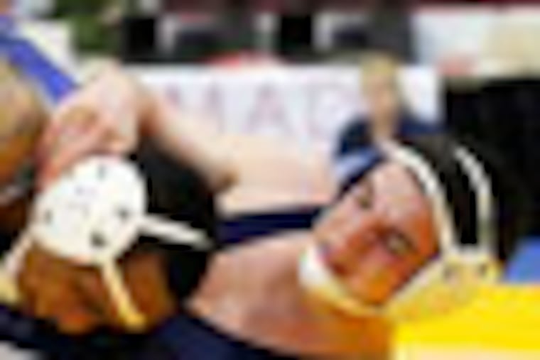 McDowell's Steve Spearman, top, puts Norristown's Mikey Springer over during their Class AAA 138-pound preliminary match at the PIAA high school wrestling championships, Thursday, March 8, 2012, in Hershey, Pa. (AP Photo/Alex Brandon)