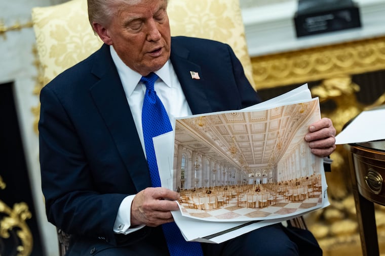 President Donald Trump shows reporters renderings of the under-construction White House ballroom on Wednesday.