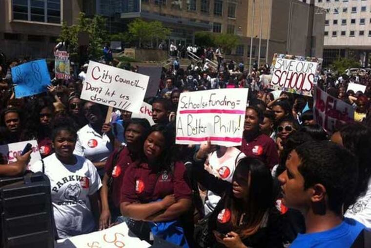 More than 2,000 students left their classes at noon to rally outside the district headquarters and protest proposed education cuts. (ED HILLE / Staff Photographer)