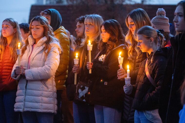 Boise State University students, along with people who knew the four University of Idaho students who were found killed in Moscow, Idaho, days earlier, pay their respects at a vigil in November.